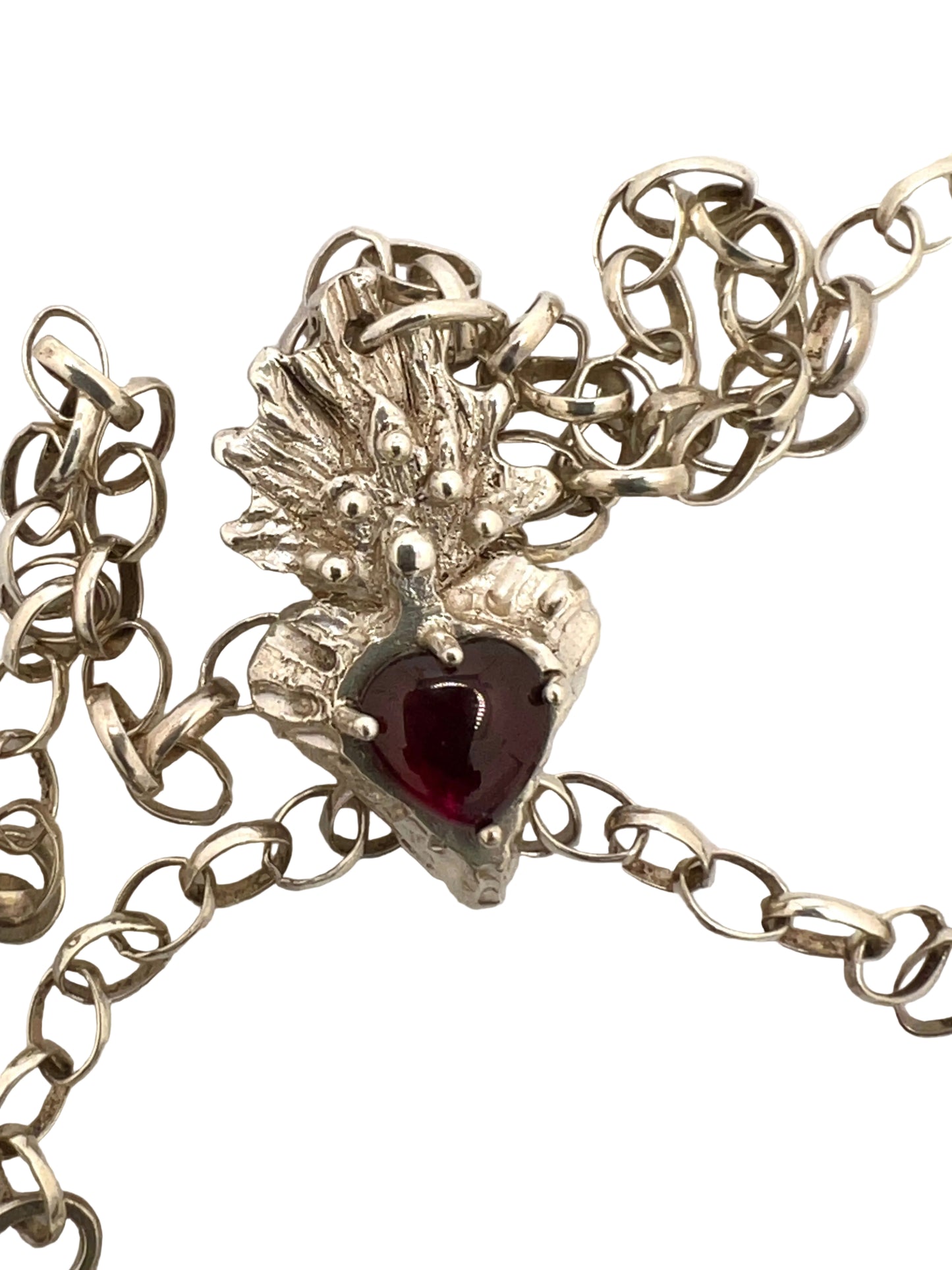 Silver flaming heart with large garnet stone
