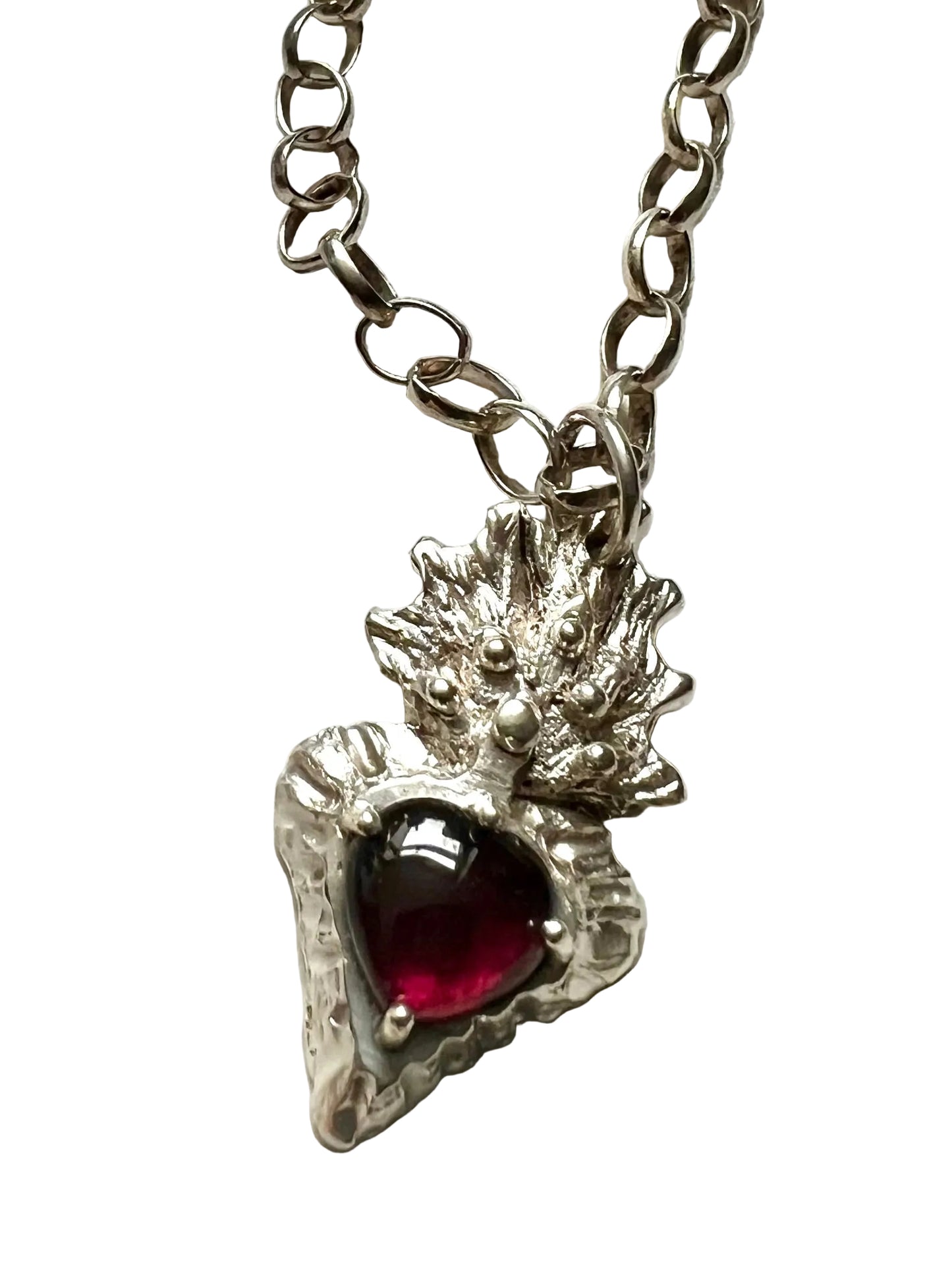 Silver flaming heart with large garnet stone