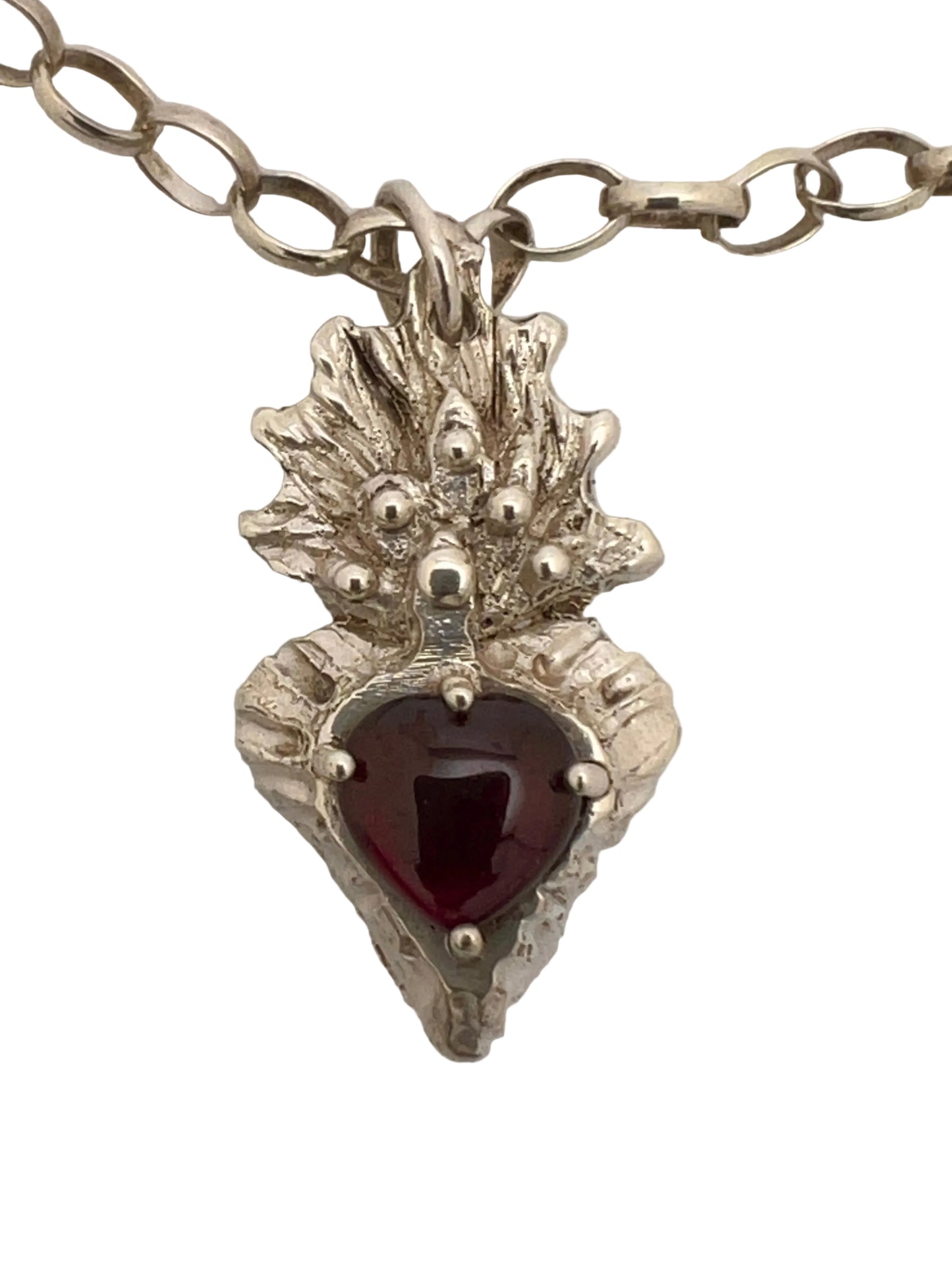 Silver flaming heart with large garnet stone
