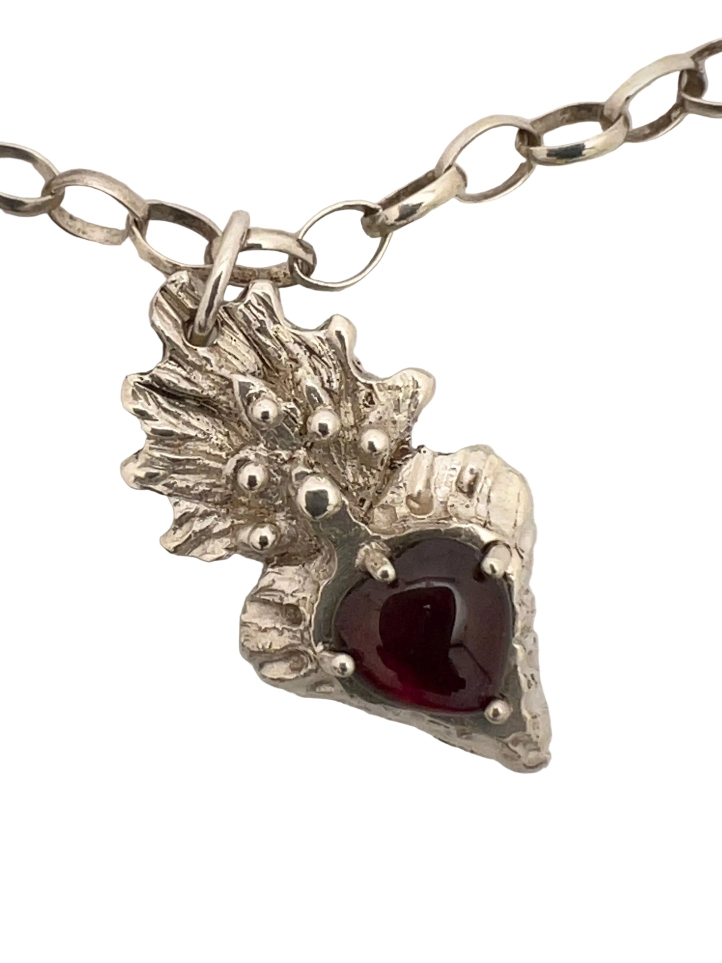 Silver flaming heart with large garnet stone